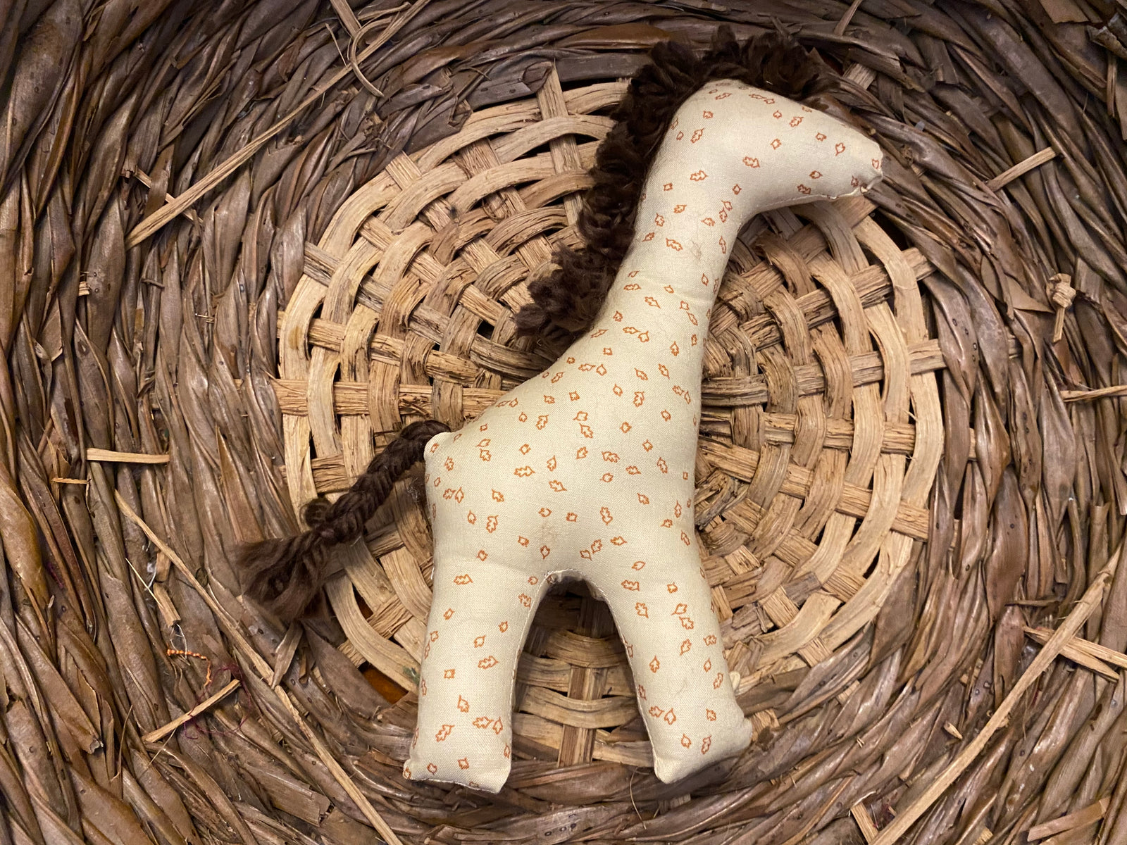 Giraffe light yellow with brown leaves, brown mane and tail