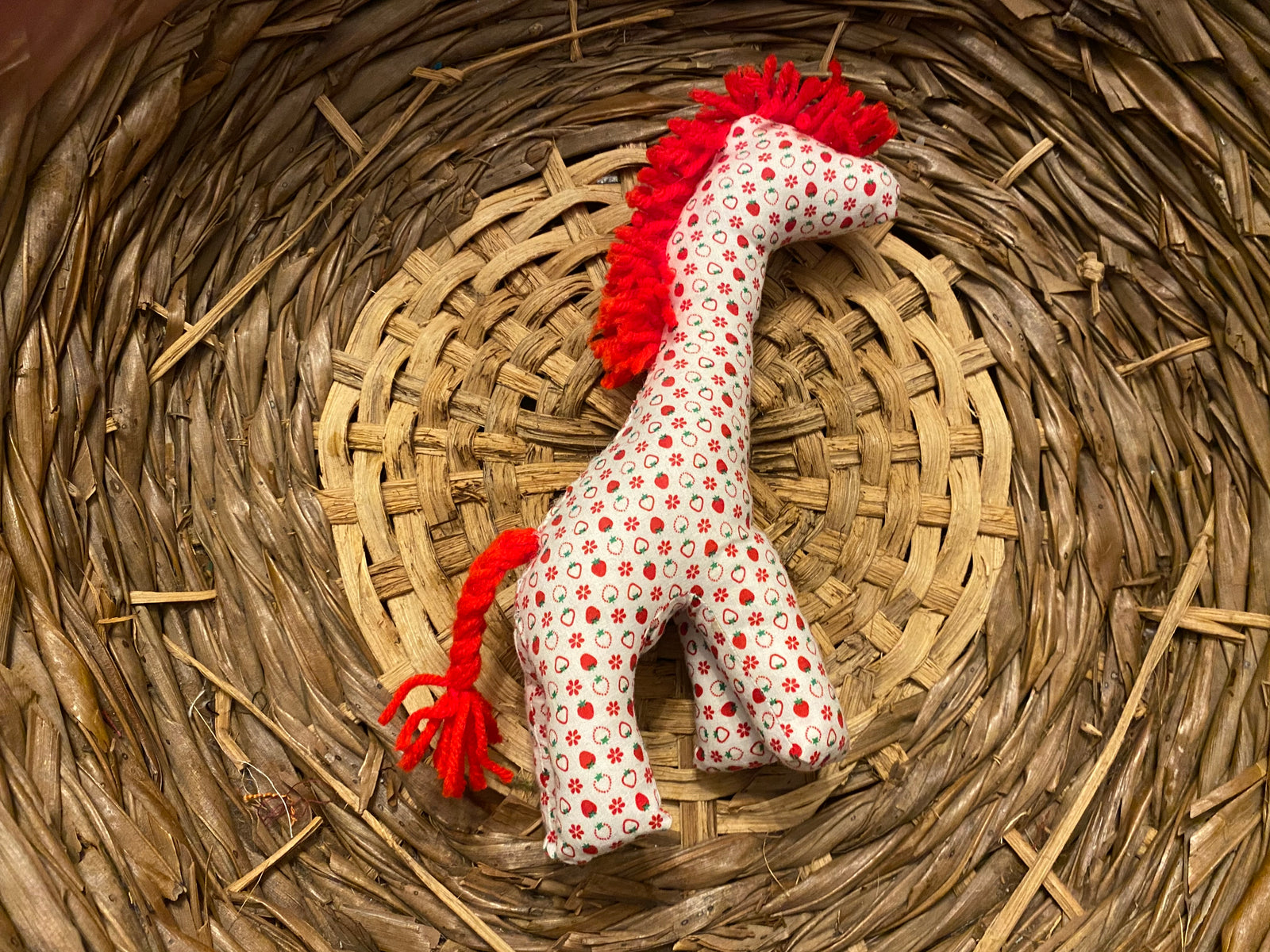 Giraffe white with red strawberries and flowers