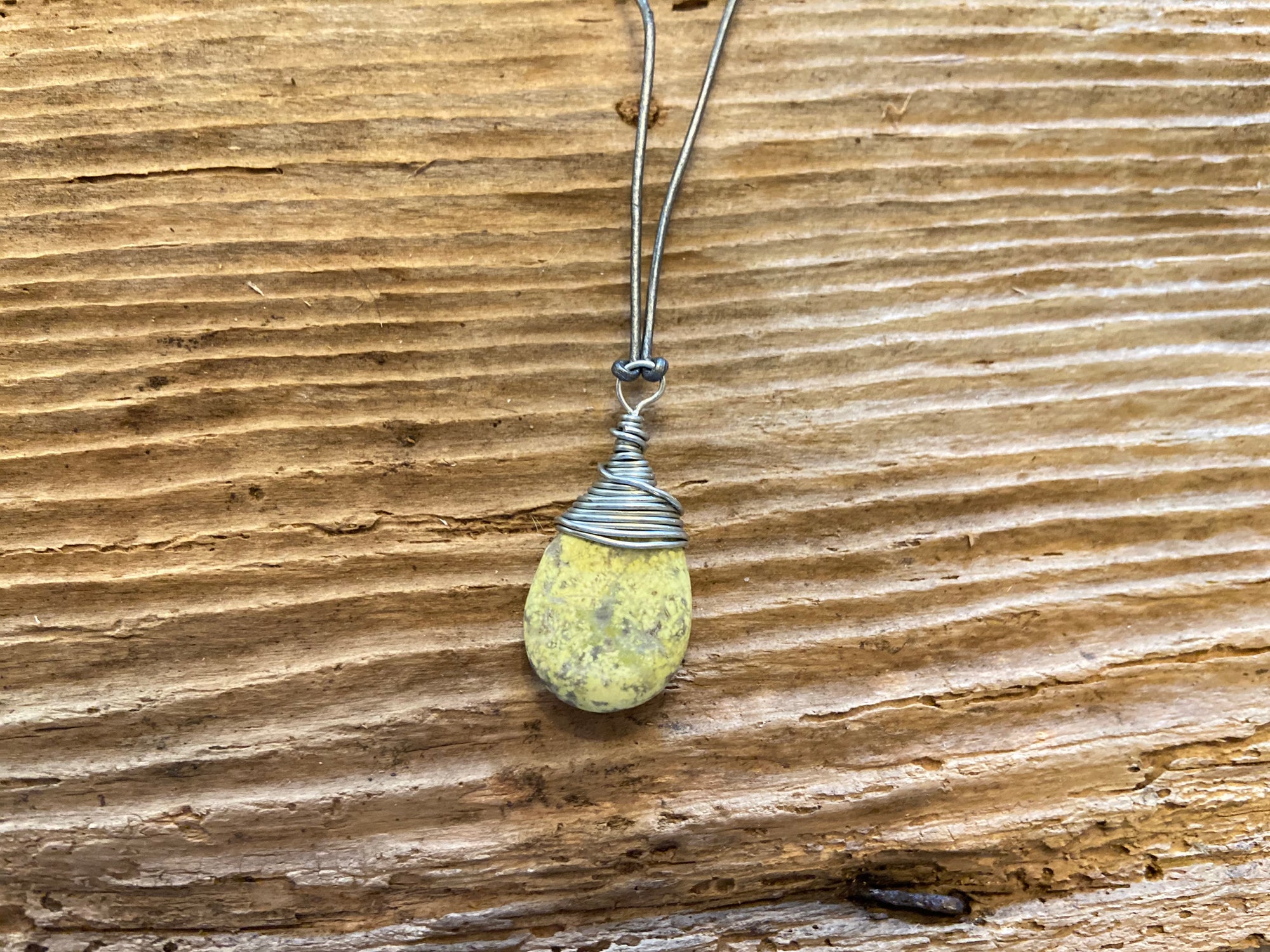 B. Light Necklace Polished Pale Yellow Stone wrapped in Silver Wire on Gray Leather Cord