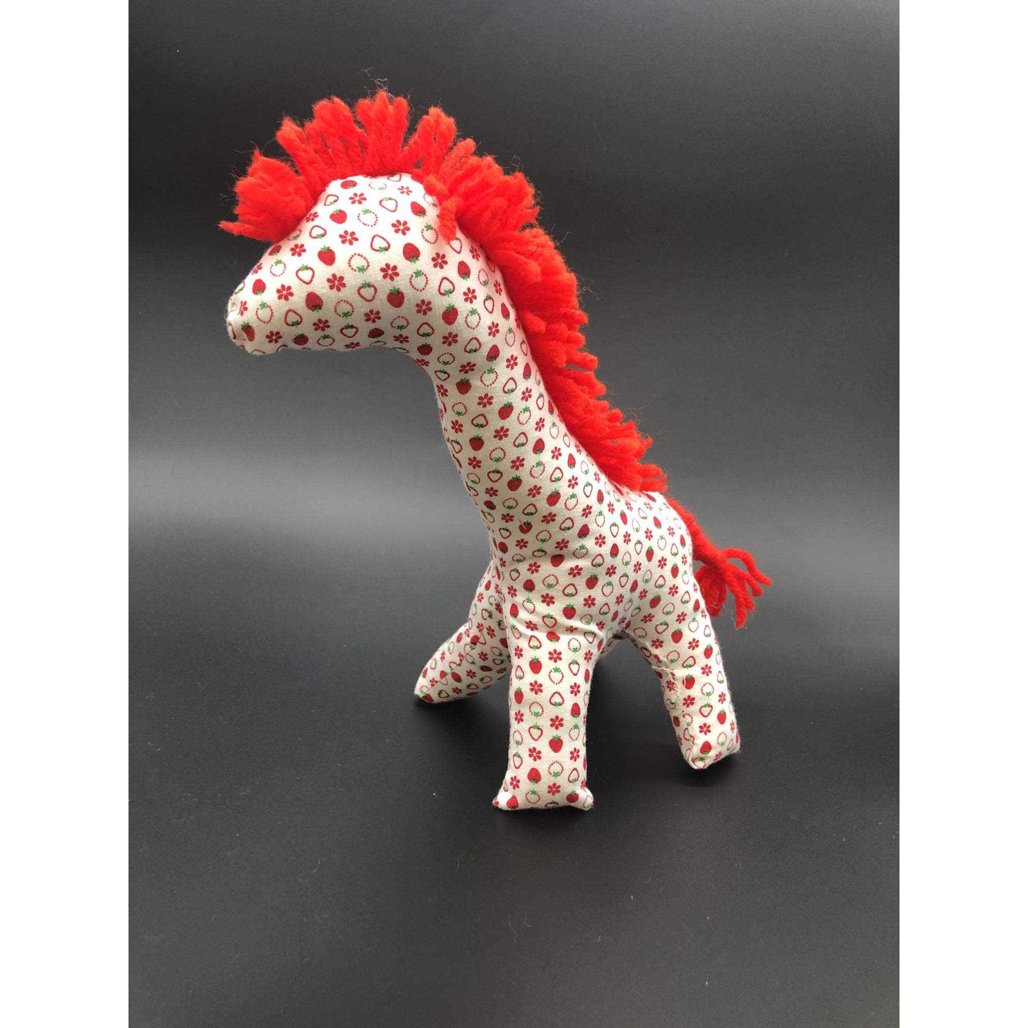 Giraffe white with red strawberries and flowers